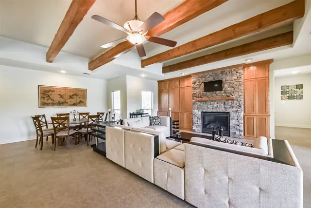 a living room with furniture a fireplace and a chandelier