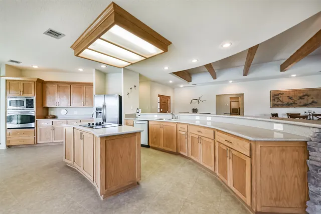 a kitchen with sink stove and refrigerator