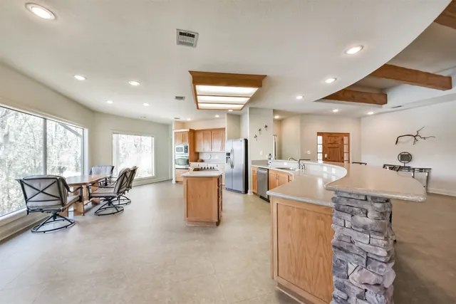 a living room with furniture a dining table and chairs