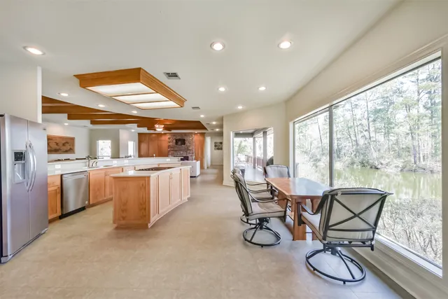 a kitchen with a table chairs and a refrigerator
