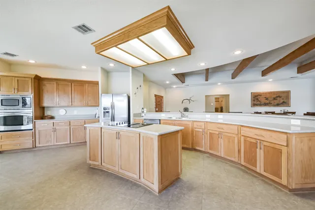 a kitchen with sink and white cabinets
