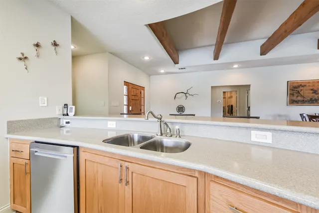 a kitchen with sink and mirror
