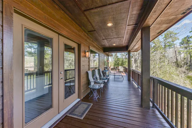 a view of a balcony with chairs and wooden floor