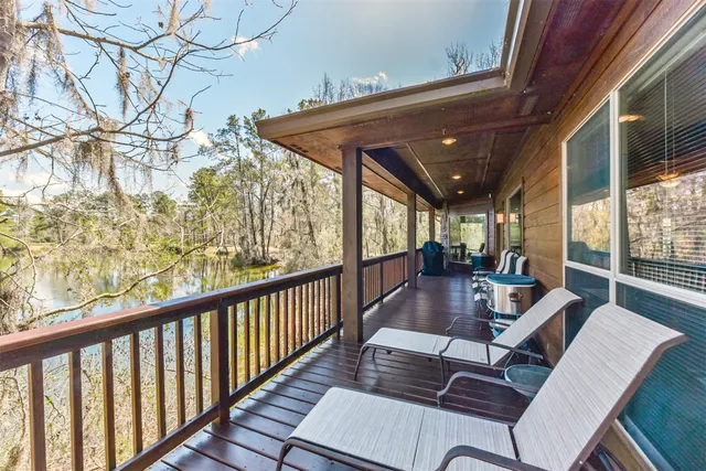 a view of balcony with furniture and wooden floor