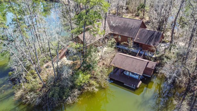 a wooden bench sitting in the middle of a lake