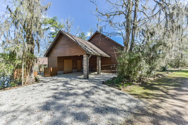 a view of a house with a yard and tree