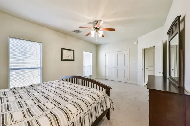 a bedroom with a large bed and a chandelier
