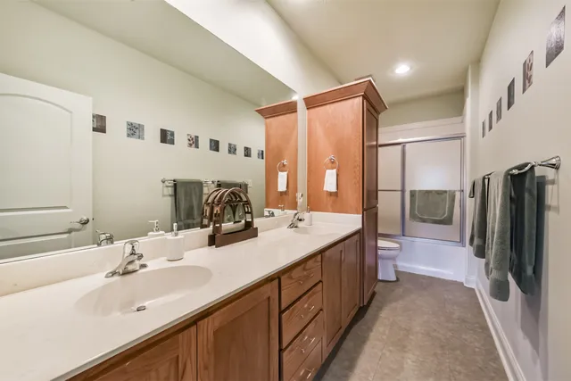 a bathroom with double vanity and a bathtub