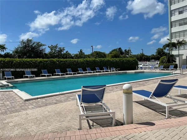a swimming pool with outdoor seating and yard