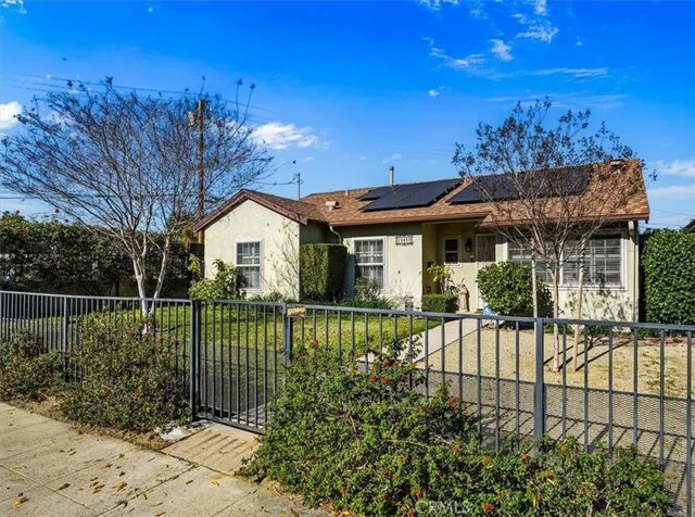 a view of a house with a wooden fence