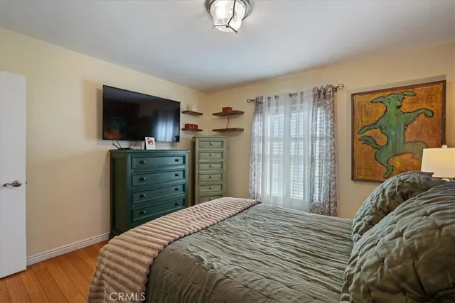 a bedroom with a bed and a television