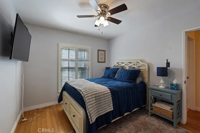 a bedroom with a bed and a flat tv screen on the dresser
