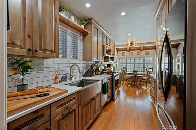 a kitchen with lots of counter top space and wooden floor