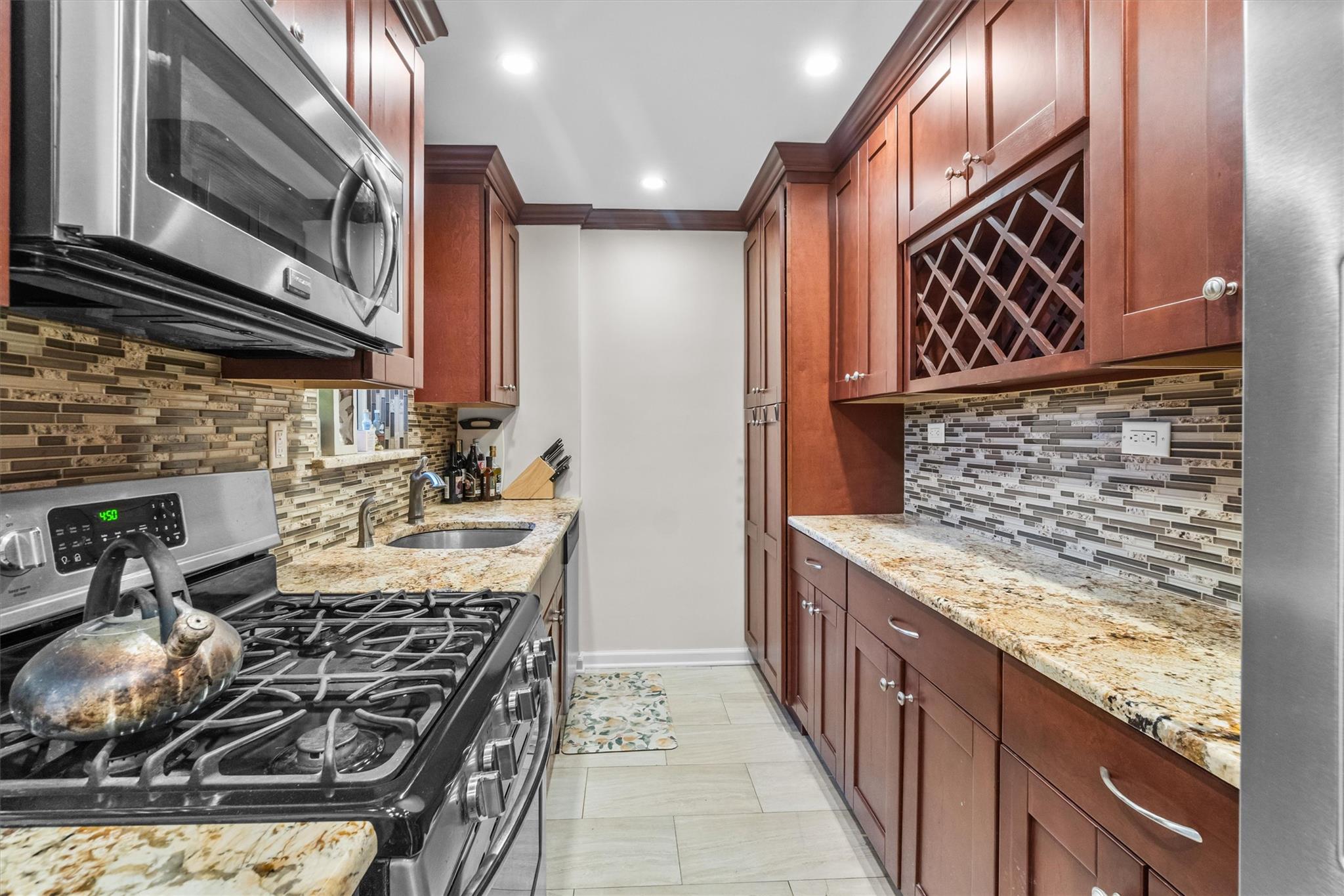a kitchen with stainless steel appliances granite countertop a stove and a sink