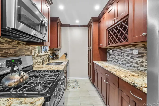 a kitchen with stainless steel appliances granite countertop a stove and a sink