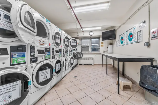 a utility room with multiple dryer and washer