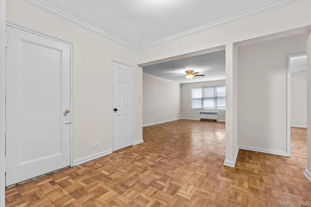 a view of empty room with wooden floor