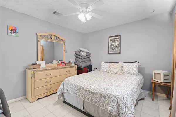 a bedroom with a bed and a mirror on dresser