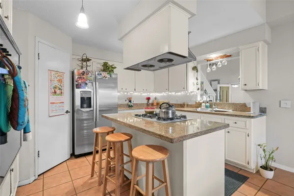 a kitchen with stainless steel appliances a sink stove and refrigerator