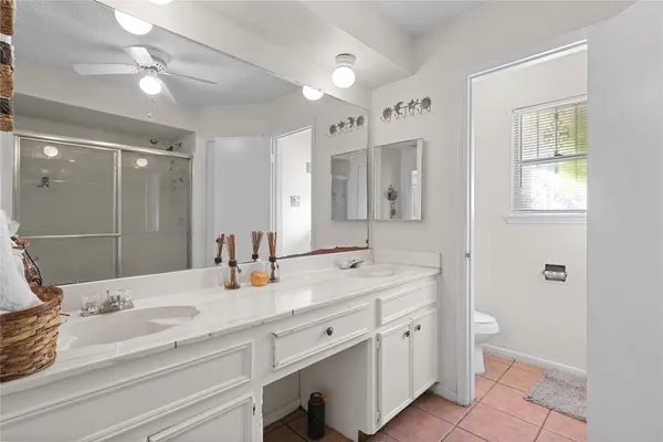 a bathroom with a double vanity sink and mirror with shower