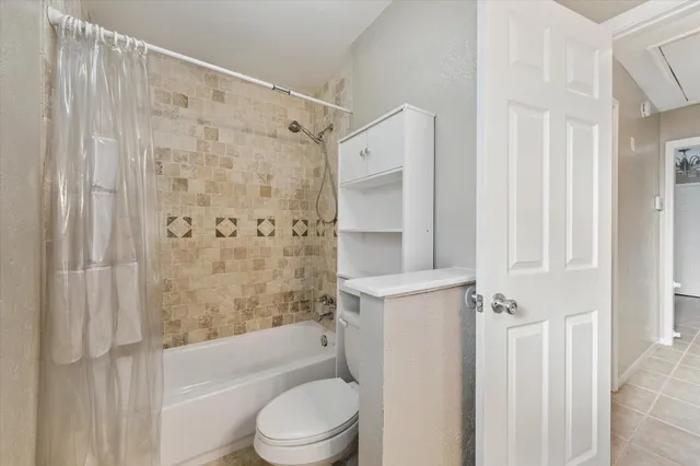 a bathroom with a bathtub shower sink vanity and toilet