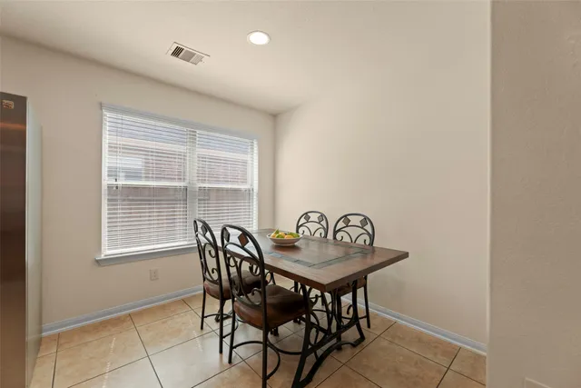 a view of a dining room with furniture and a window