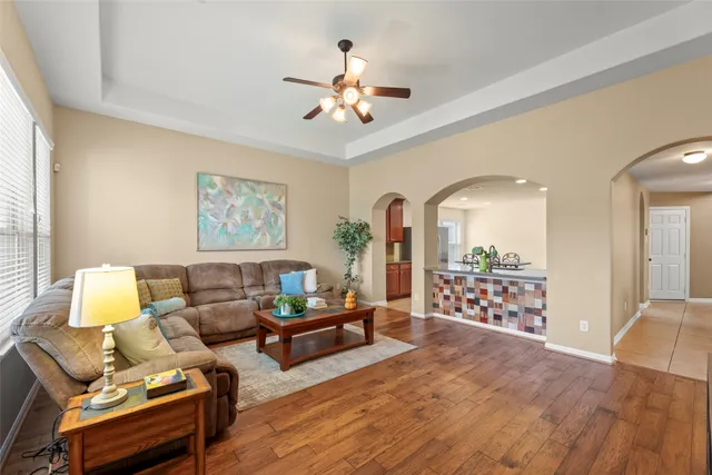 a living room with furniture and wooden floor