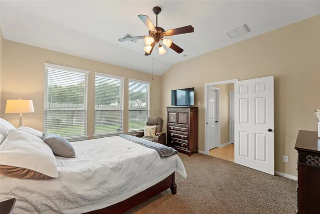 a bedroom with a bed and a large window