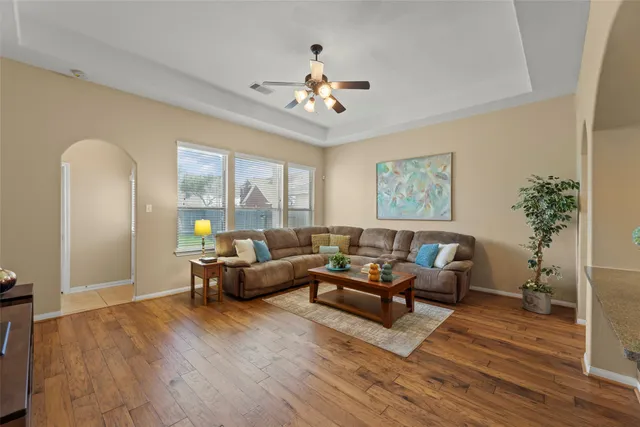 a living room with furniture and a chandelier