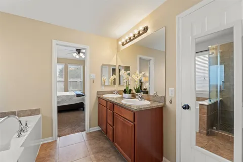 a en suite bathroom with a sink a mirror and a shower