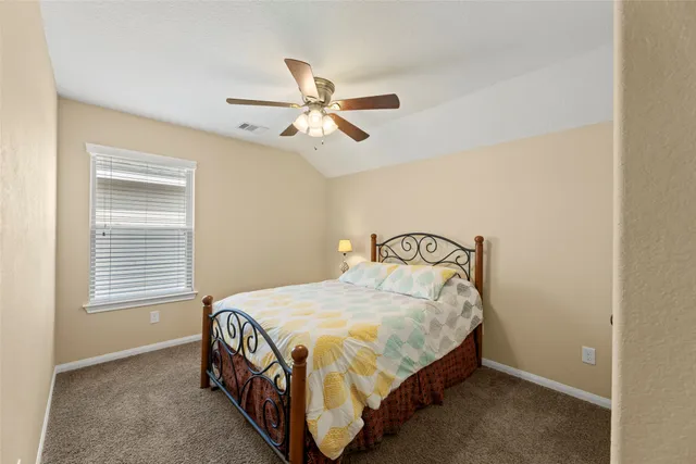 a bedroom with a bed next to a window