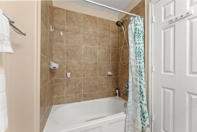 a bathroom with a bathtub and a shower