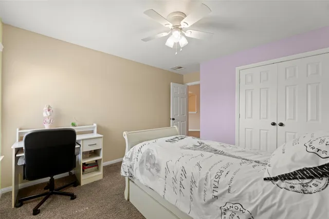 a bedroom with a bed and a chair