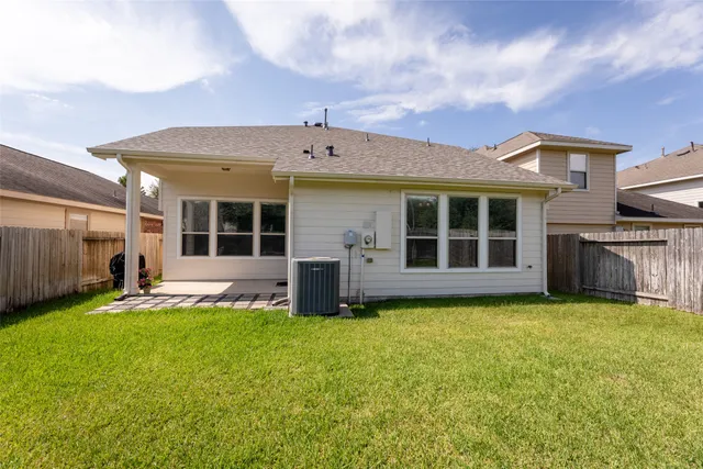 a view of a house with a yard and sitting area