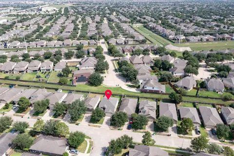 an aerial view of residential houses with outdoor space and swimming pool