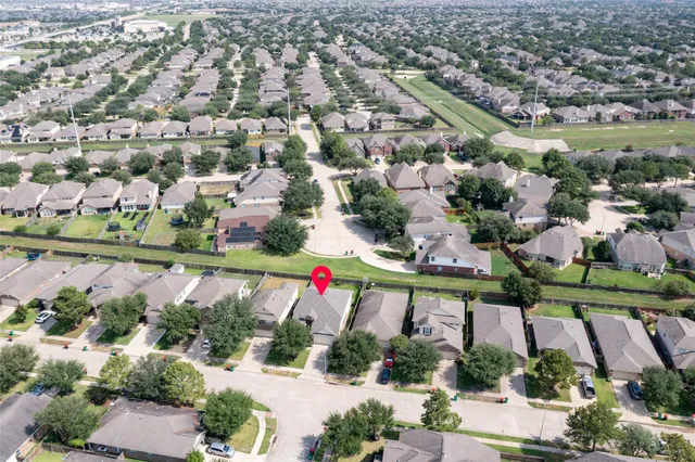 an aerial view of residential houses with outdoor space and swimming pool