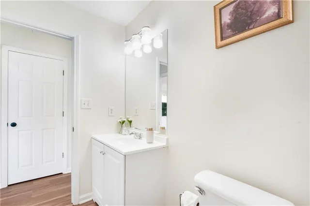a bathroom with a sink mirror and toilet