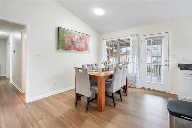 a view of a dining room with furniture and wooden floor