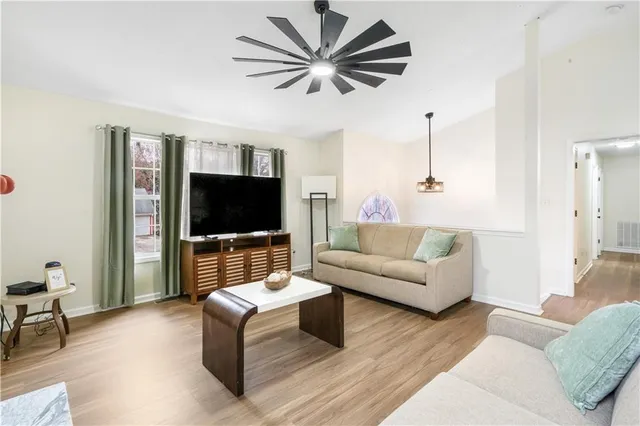 a living room with furniture and a flat screen tv