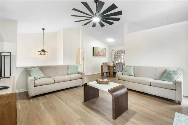 a living room with furniture and a wooden floor