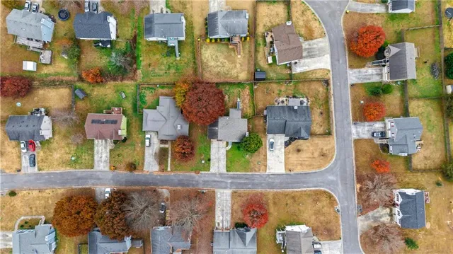 an aerial view of residential houses and outdoor space