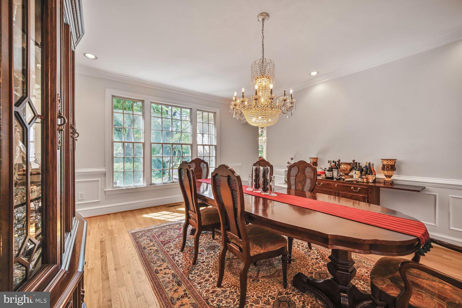 7401 Honesty Way Bethesda, MD 20817 - Photo 11 of 54 a view of a dining room with furniture a chandelier and wooden floor