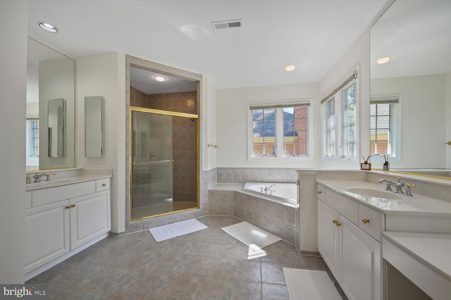 7401 Honesty Way Bethesda, MD 20817 - Photo 21 of 54 a spacious bathroom with a granite countertop sink mirror and double