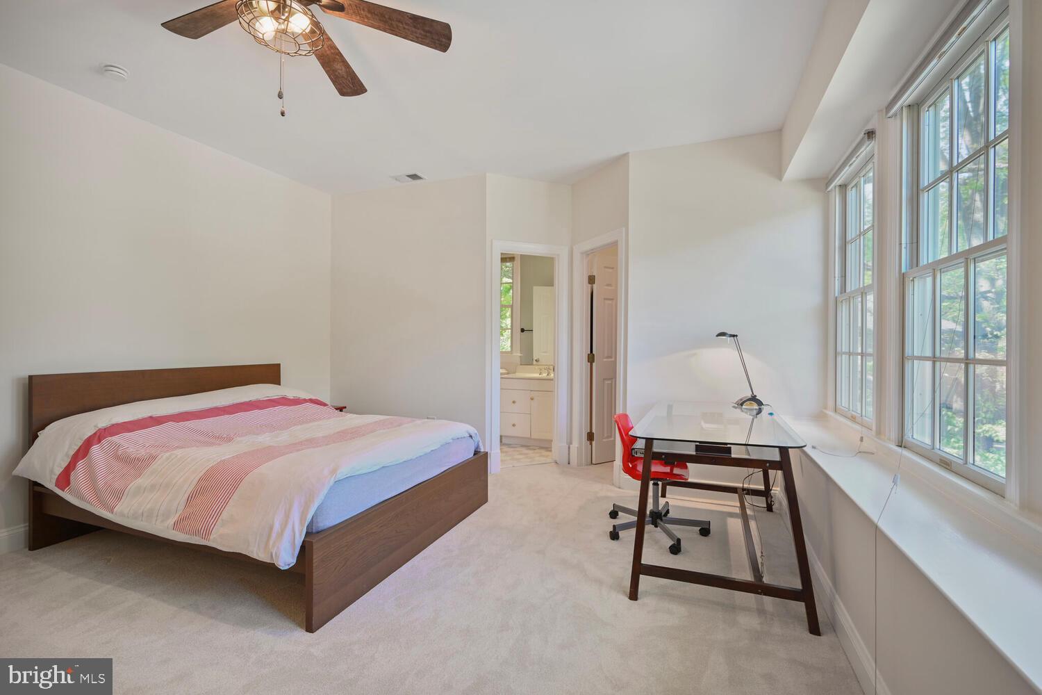 7401 Honesty Way Bethesda, MD 20817 - Photo 28 of 54 a bedroom with a bed a chair and a chandelier