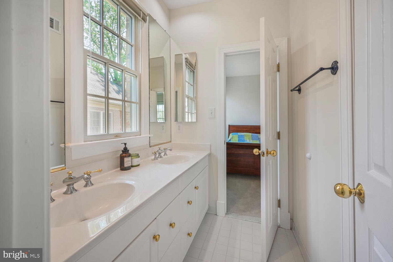 7401 Honesty Way Bethesda, MD 20817 - Photo 34 of 54 a en suite bathroom with a granite countertop sink and a mirror