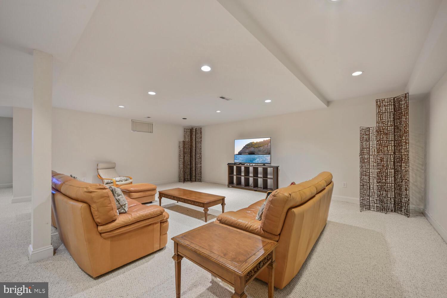 7401 Honesty Way Bethesda, MD 20817 - Photo 39 of 54 a living room with furniture a ceiling fan and a rug