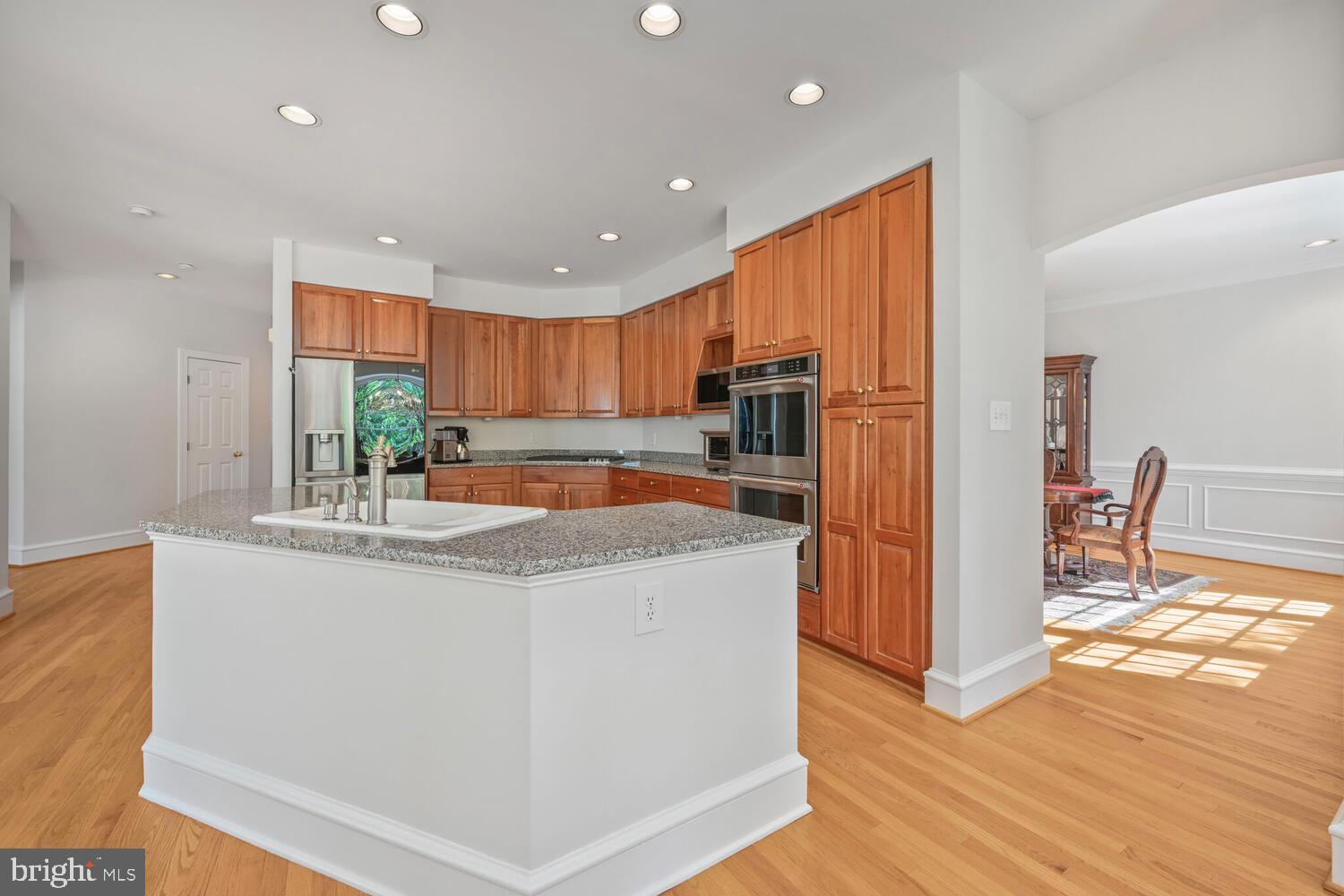 7401 Honesty Way Bethesda, MD 20817 - Photo 4 of 54 a kitchen with stainless steel appliances granite countertop a refrigerator a sink a stove a microwave and island