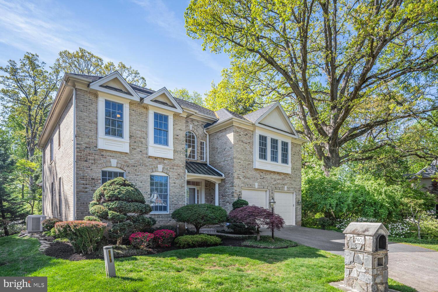 7401 Honesty Way Bethesda, MD 20817 - Photo 45 of 54 a front view of a house with a yard and potted plants