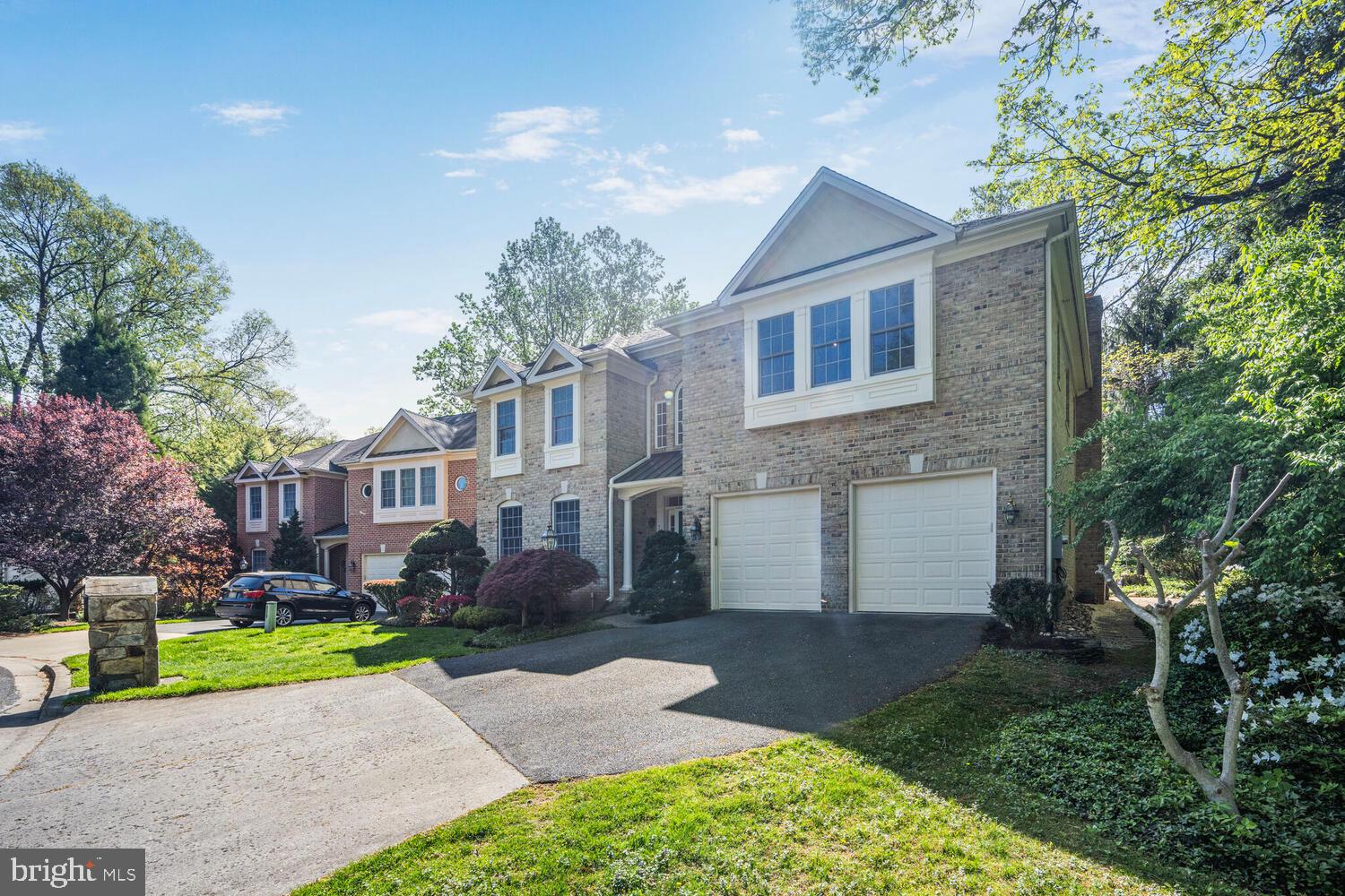 7401 Honesty Way Bethesda, MD 20817 - Photo 46 of 54 a view of a white house next to a yard and a large tree
