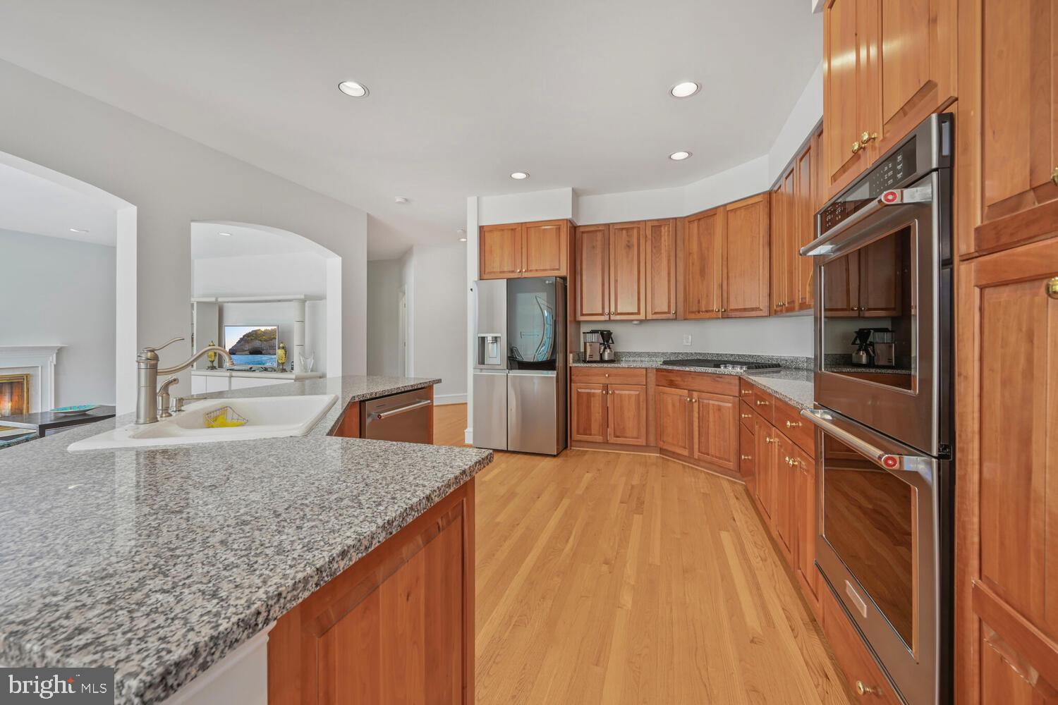 7401 Honesty Way Bethesda, MD 20817 - Photo 5 of 54 a large kitchen with kitchen island a large counter top stainless steel appliances and cabinets